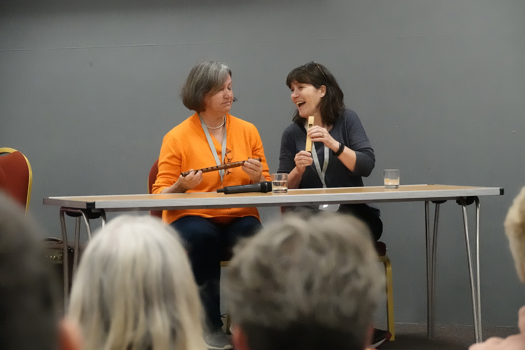 Kim Topham and Rosie Moss sitting at a table laughing