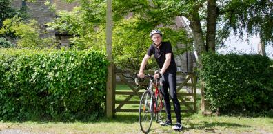 Bishop John on his bike outside Stock & Bradley church