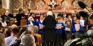 Children singing at Five Alive carol service_header