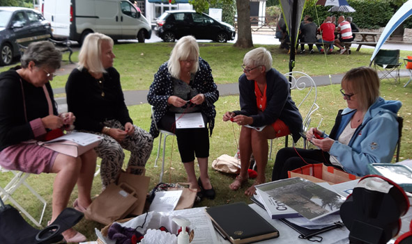 people knitting poppies together