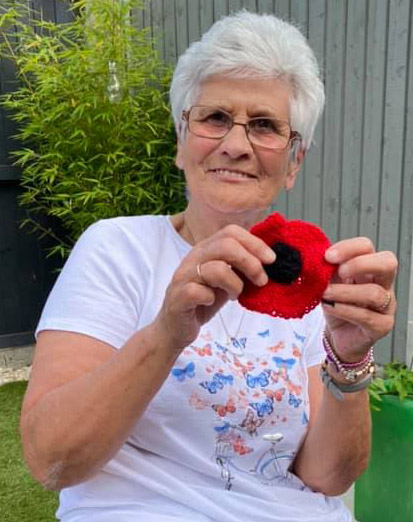 Someone knitting a poppy