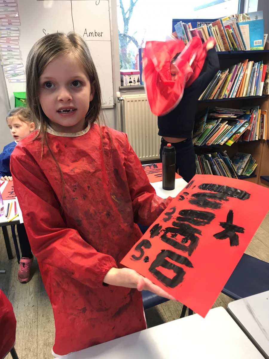 Girl shows painting in Chinese