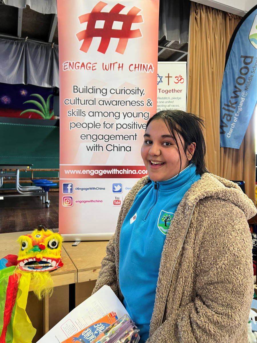 Girl in front of an engage with China banner