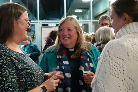 Anne Potter chatting with others at the celebration