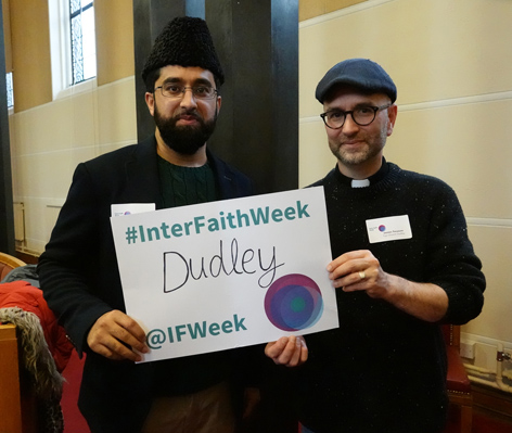 James treasure & Muslim leader holding up Interfaith Week sign