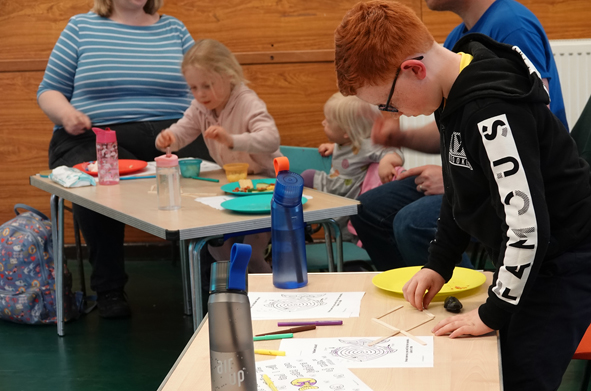 Boy creating a fish from lolly sticks