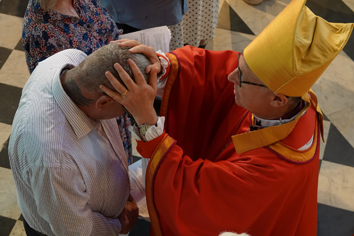 Mark Hewitt being confirmed by Bishop Martin