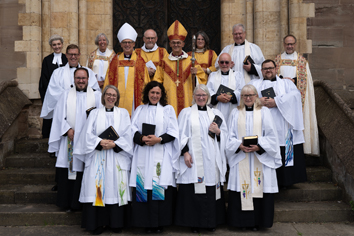 Priests standing with Bishops john and Martin outside the cathedral after their ordination